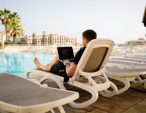  Digital nomad working by the pool