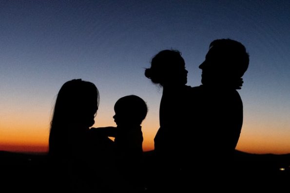 A silhouette of a family of four