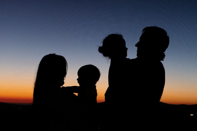 A silhouette of a family of four