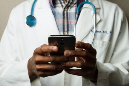 A doctor using his phone.
